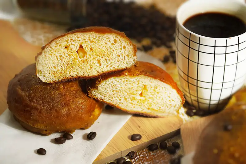 Delicious baked breakfast buns served with a cup of coffee. Perfect start to the day.