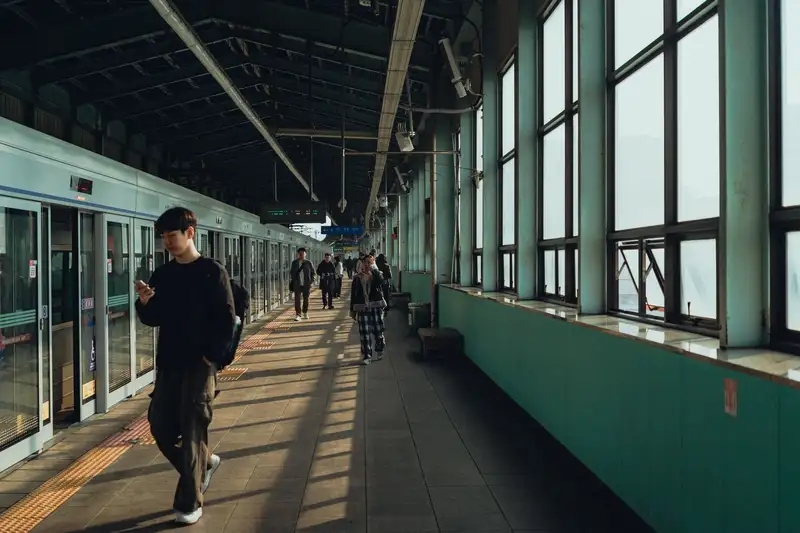 A serene view of people in a Seoul metro station, capturing everyday city life.
